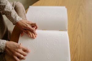 Photo by Yan Krukau: https://www.pexels.com/photo/a-person-assisting-a-child-read-a-braille-book-7694415/